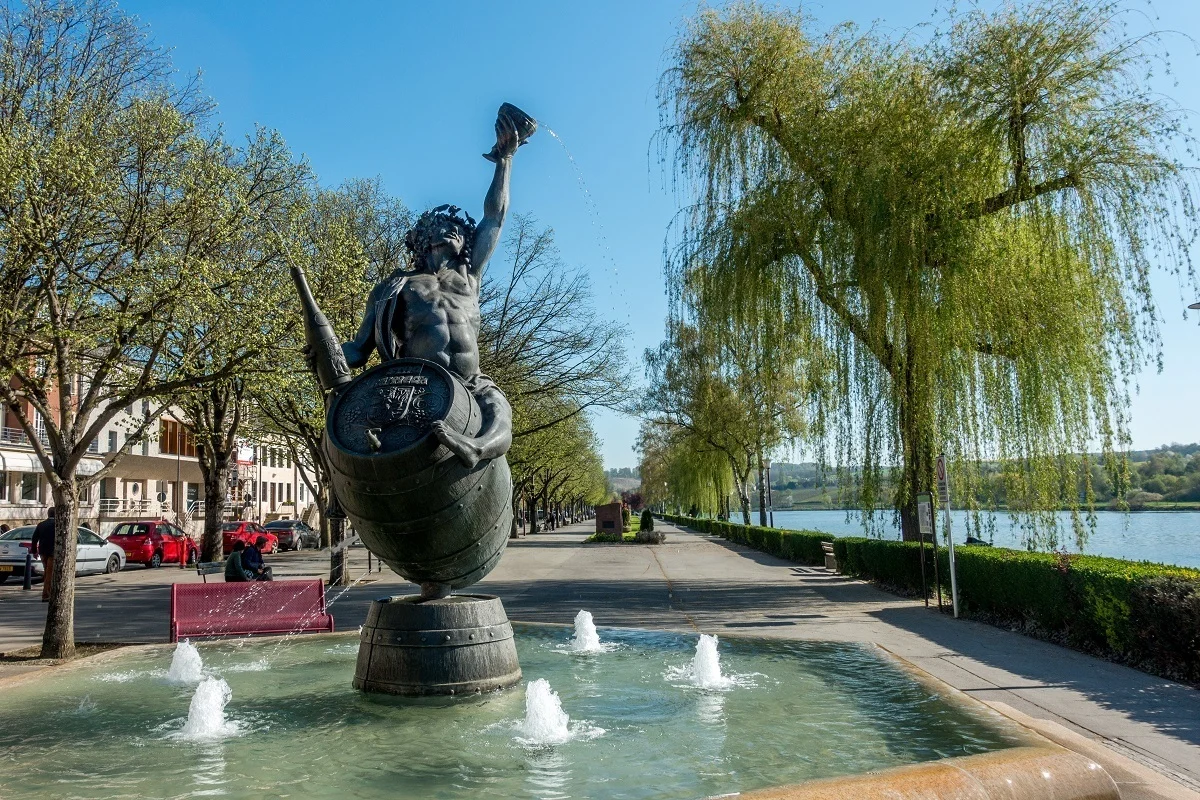Bacchus fountain near river in Remich, Luxembourg