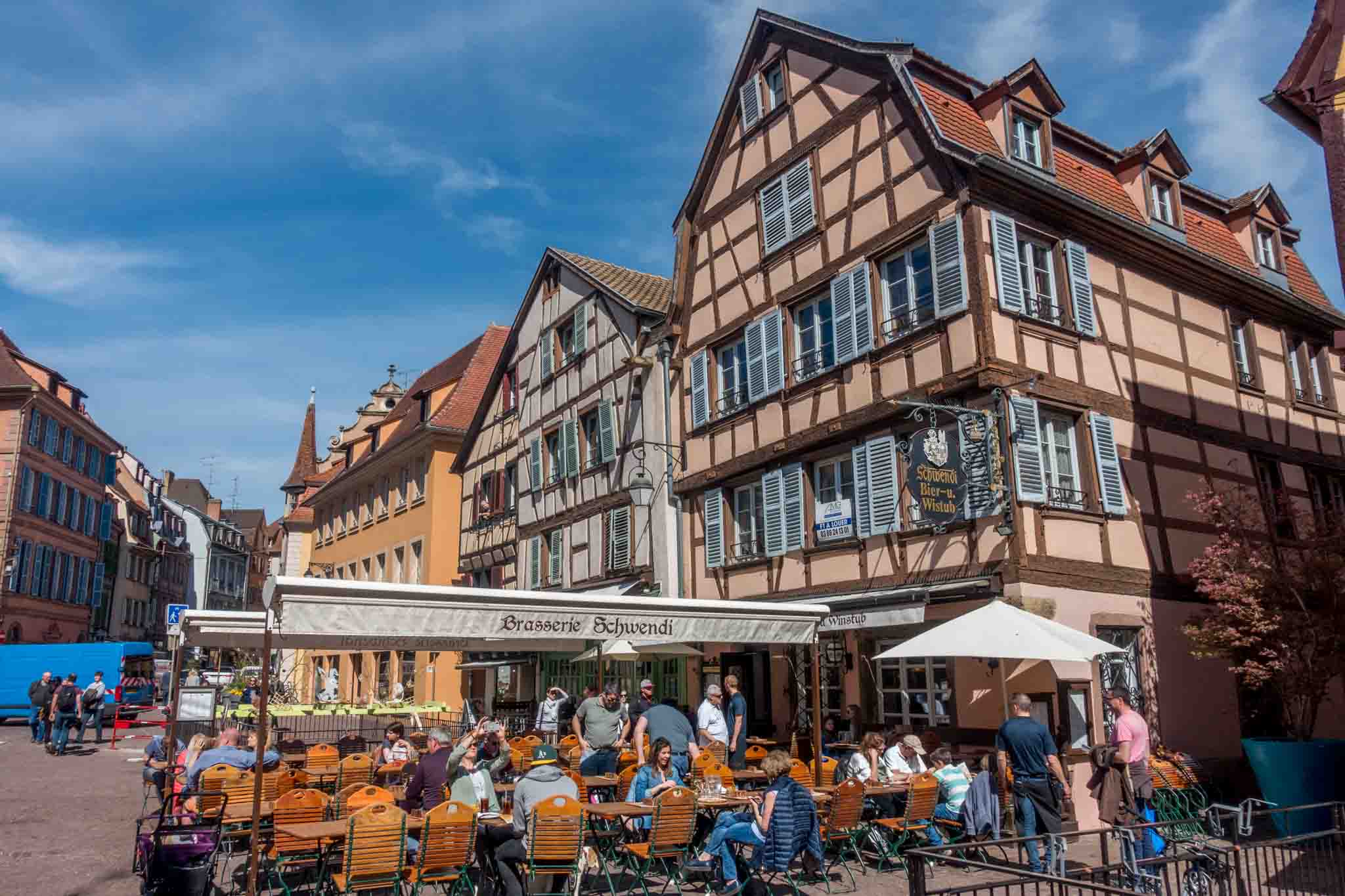 People eating at an outdoor cafe in a town square