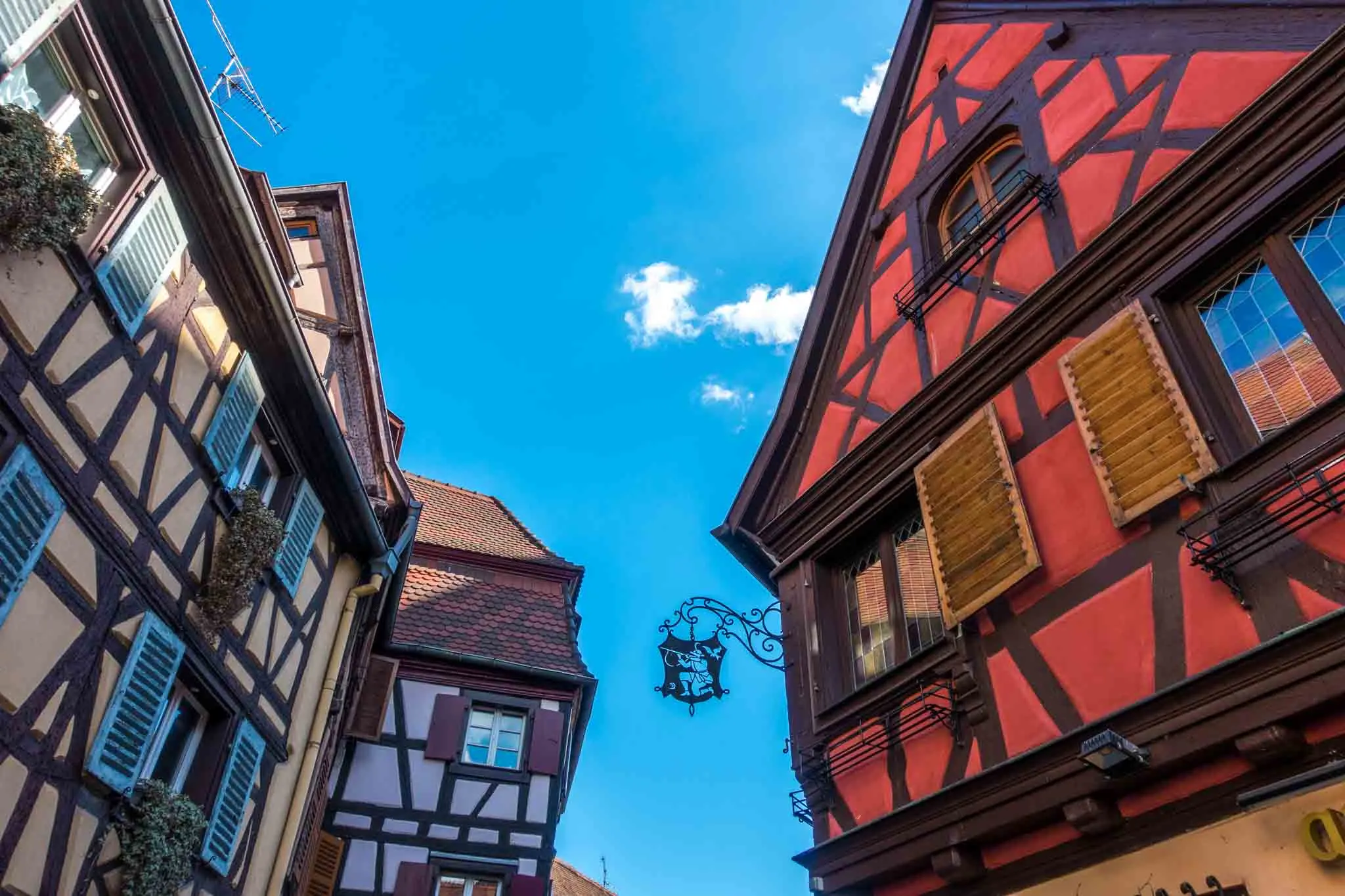 Half-timbered buildings with an iron sign.