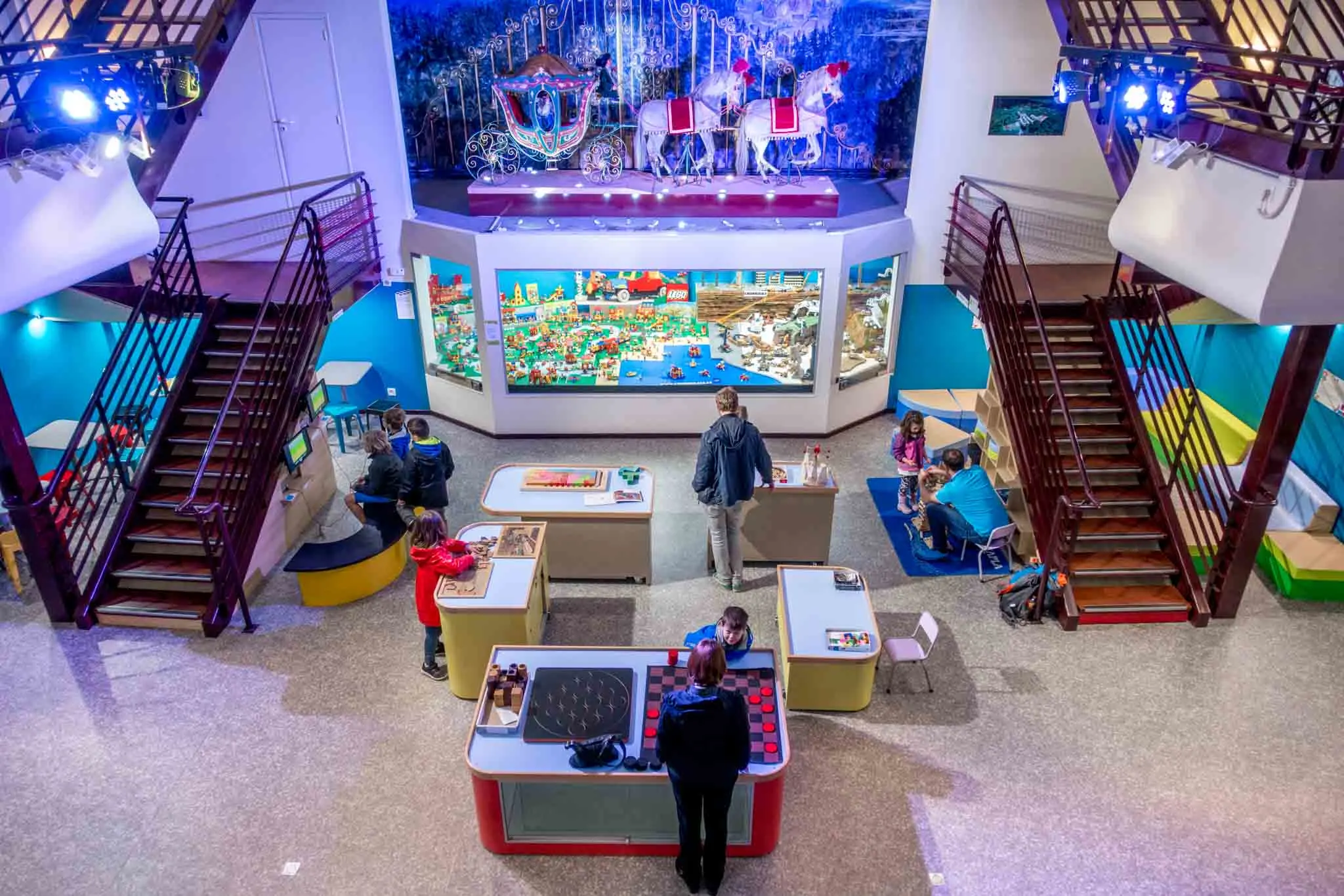 Families playing games inside the Toy Museum