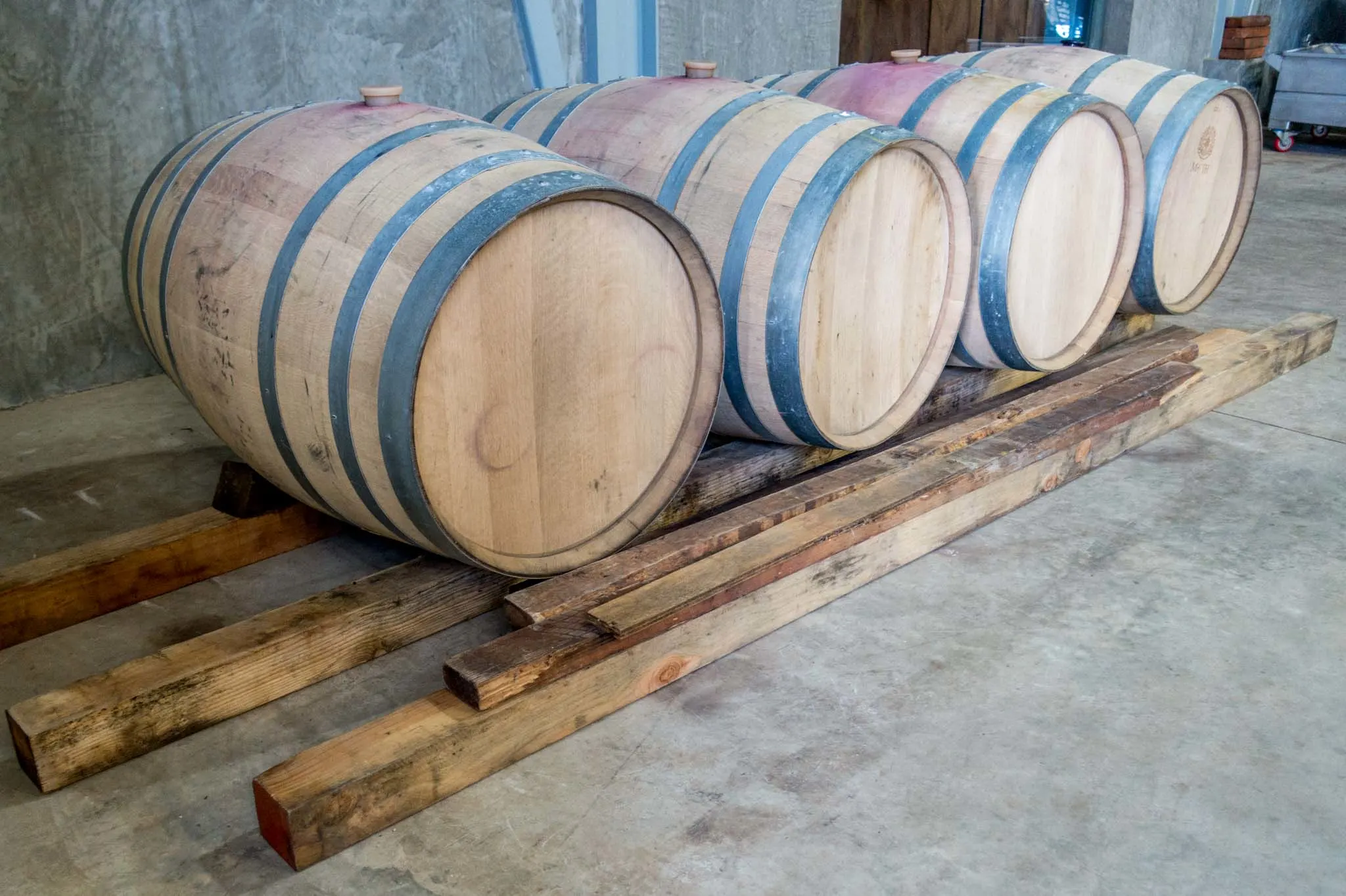 Oak aging barrels at a winery