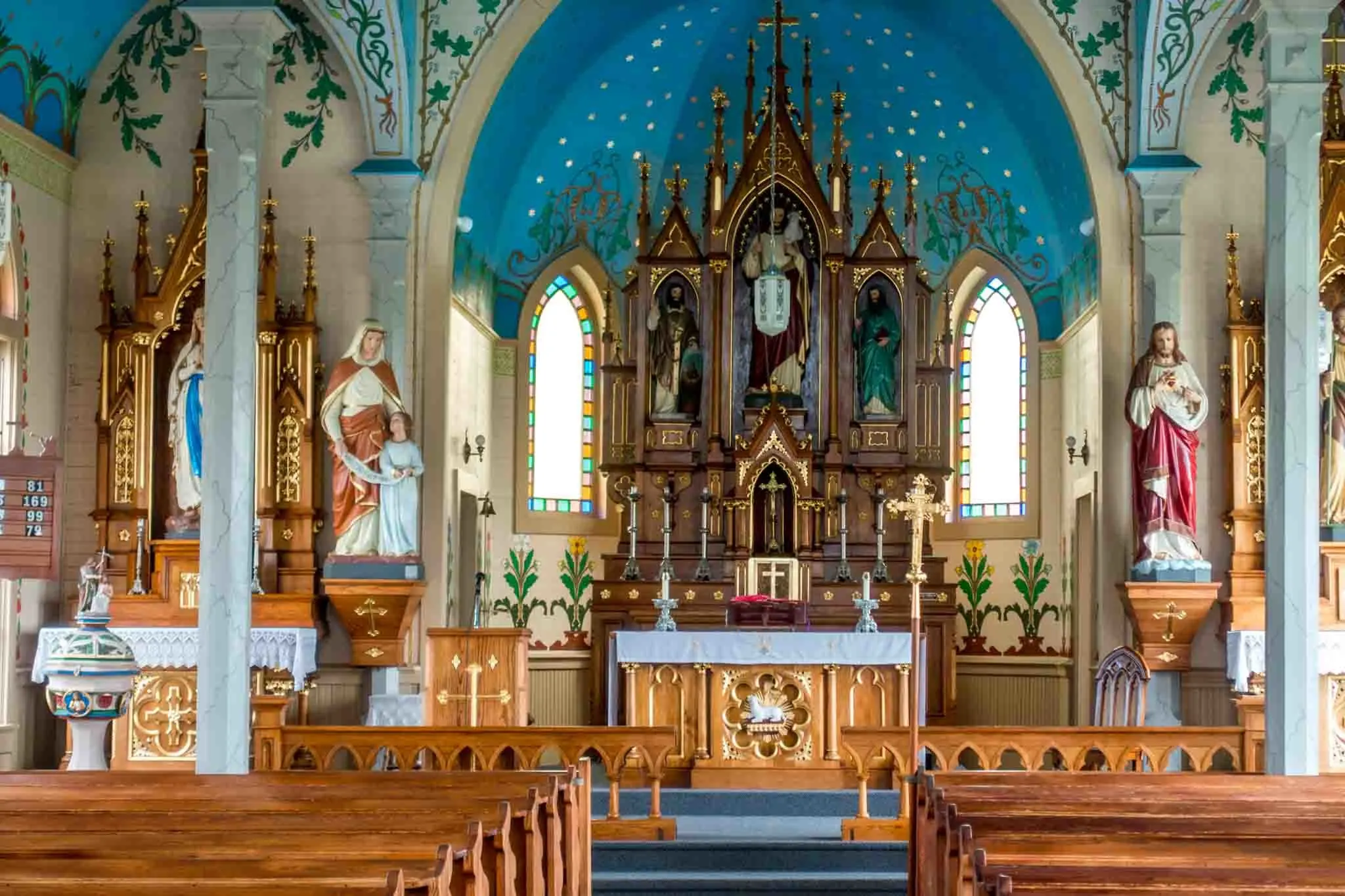 Brightly-painted sanctuary with altar and religious statues