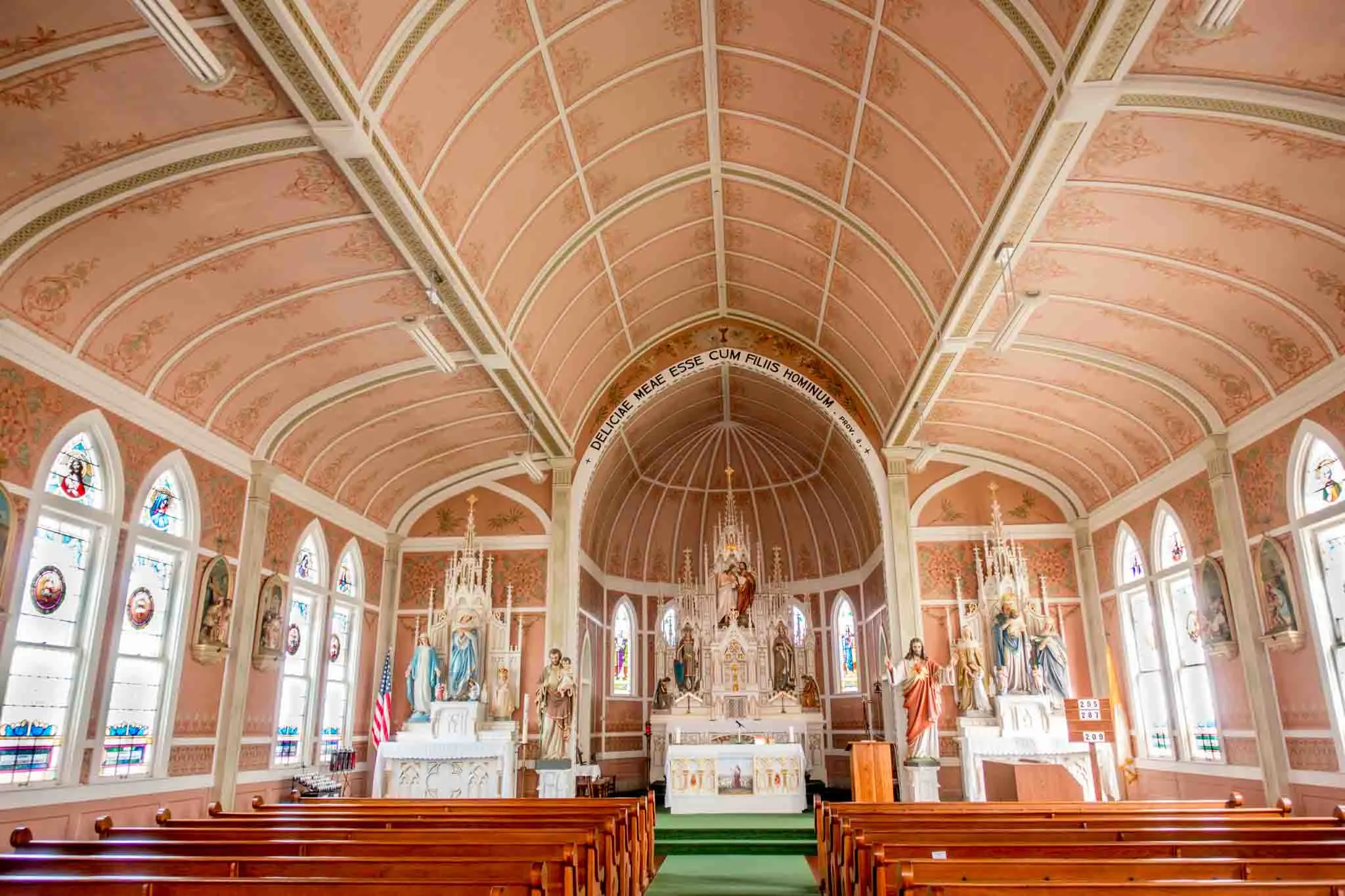 Pink sanctuary of St. John the Baptist with religious statues