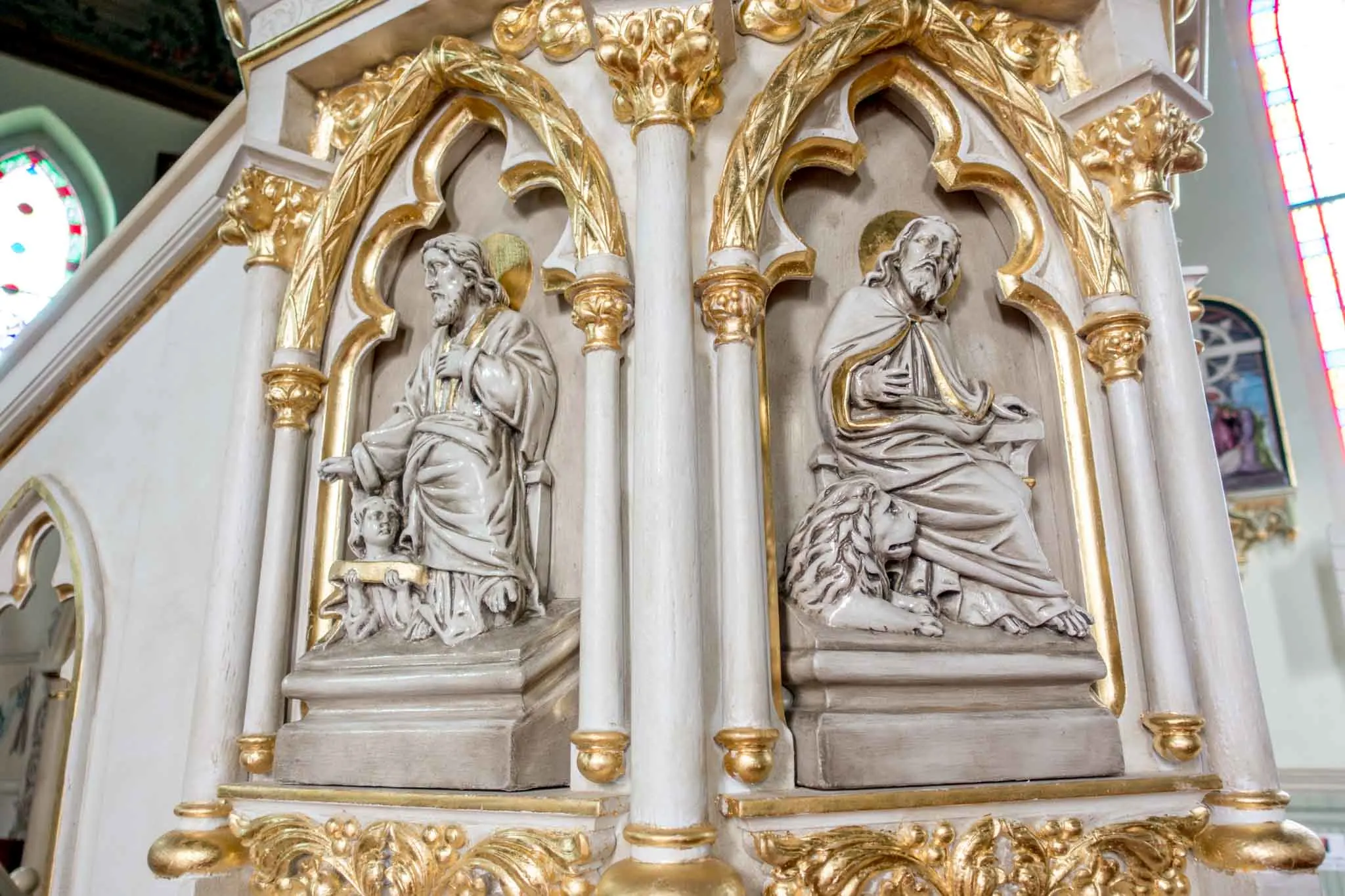 Statues on the base of a pulpit