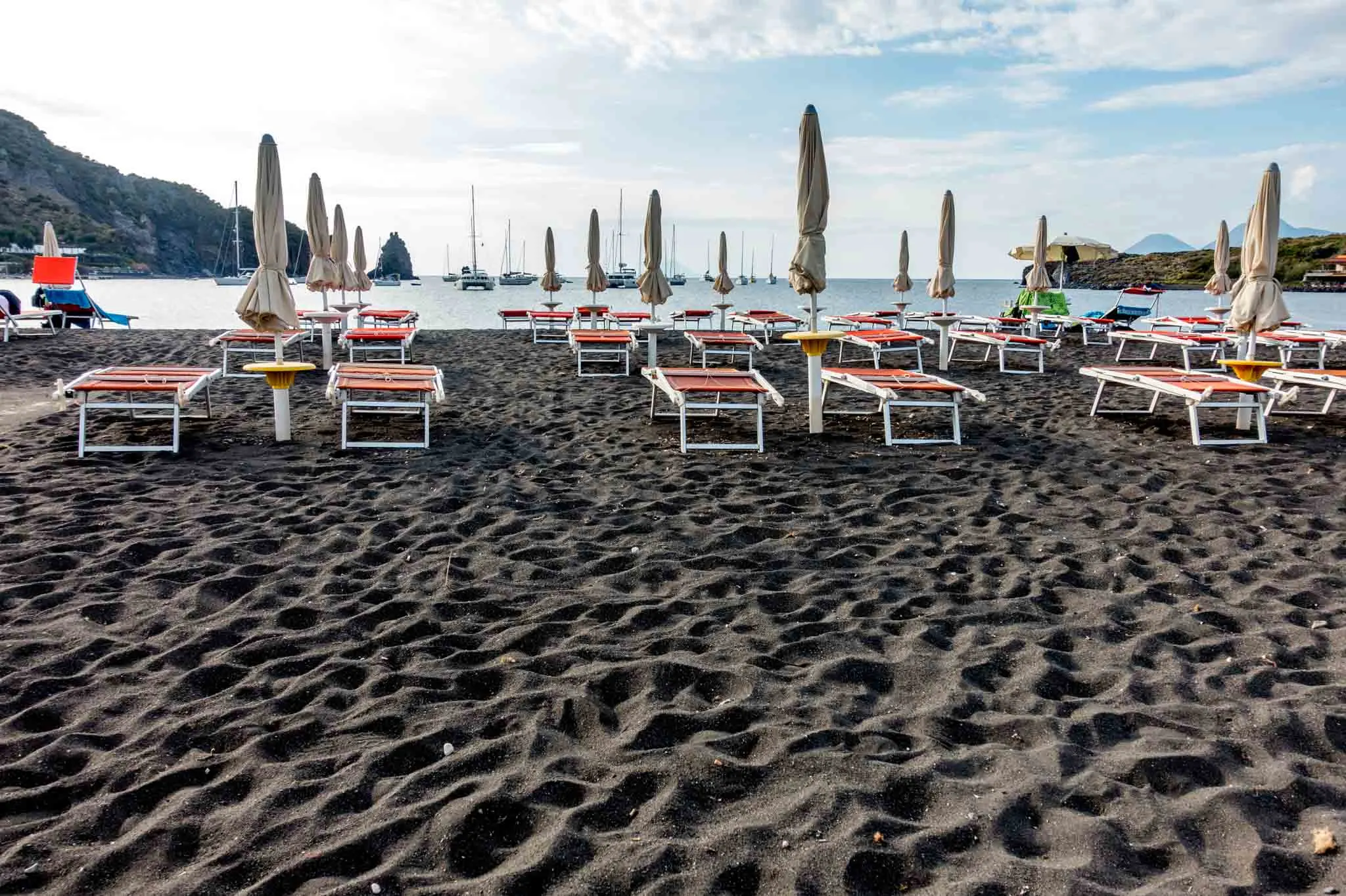 Chairs on black sand beach