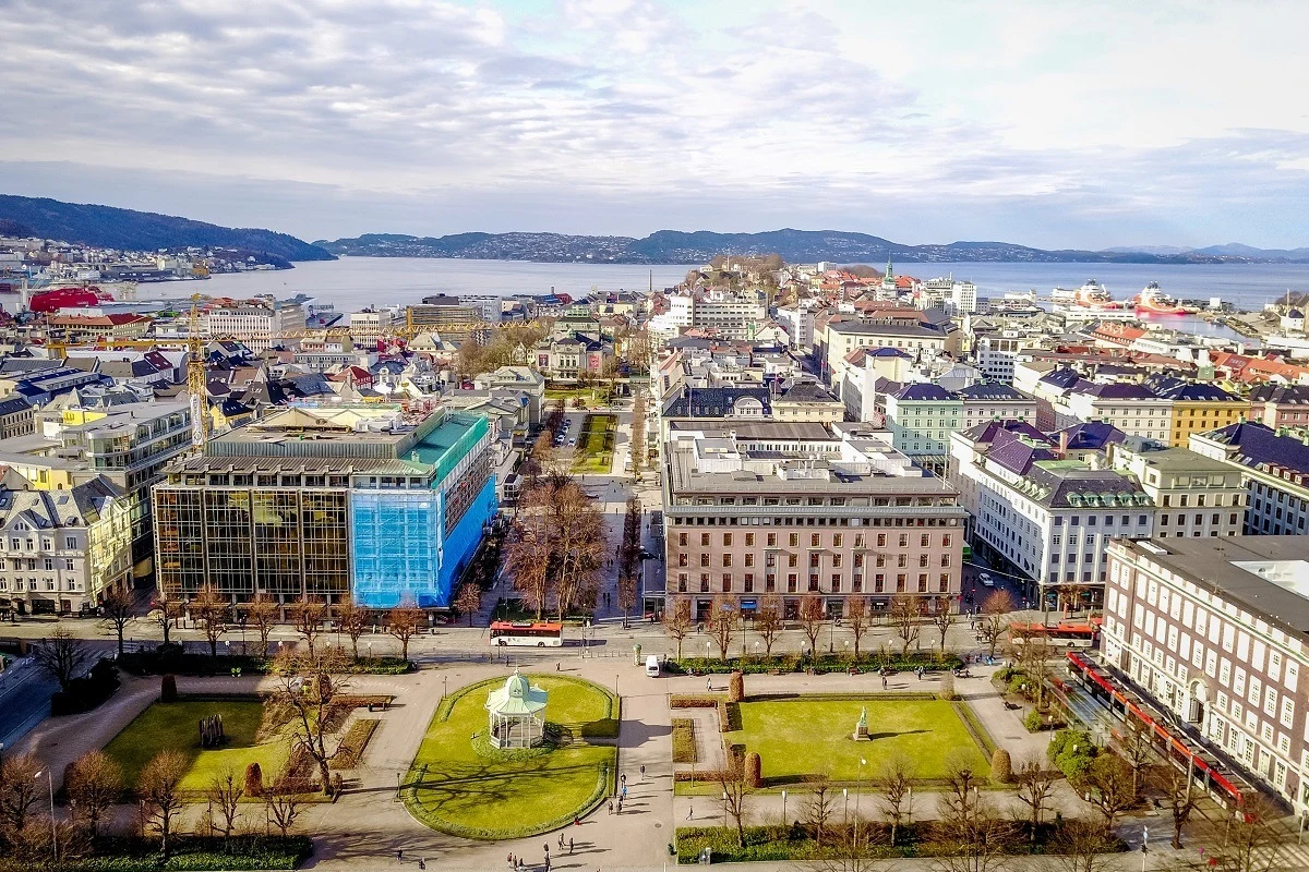 Overhead view of buildings and a grassy square along the coast