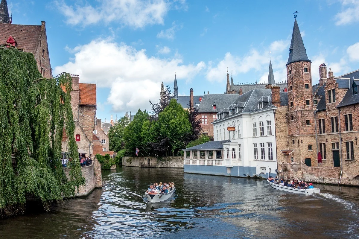 Two boats in canal with historic buildings on both sides