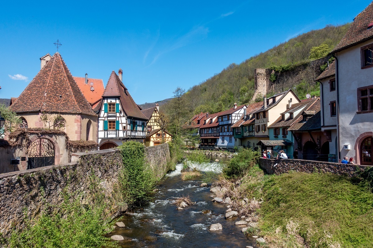 Half-timbered buildings beside river in Kaysersberg, part of the Alsace wine route