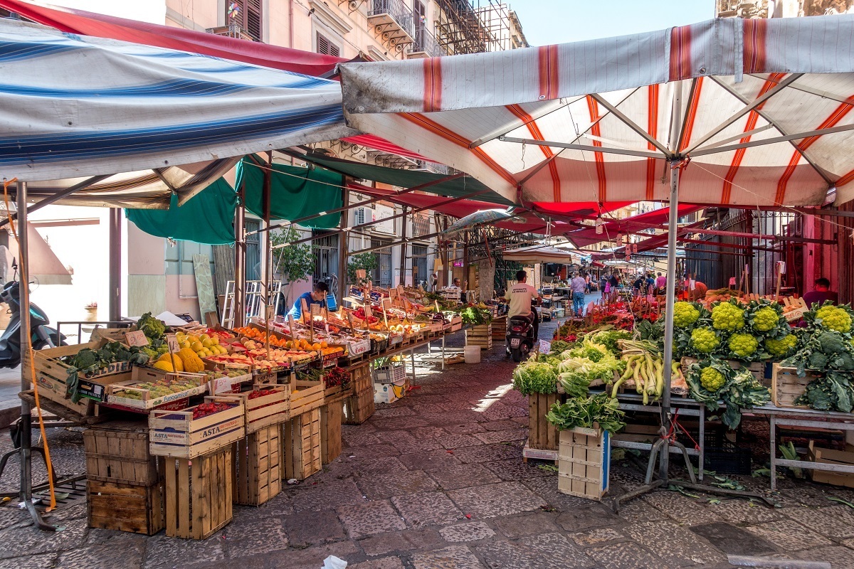 Produce displayed under tents in the middle of the street 