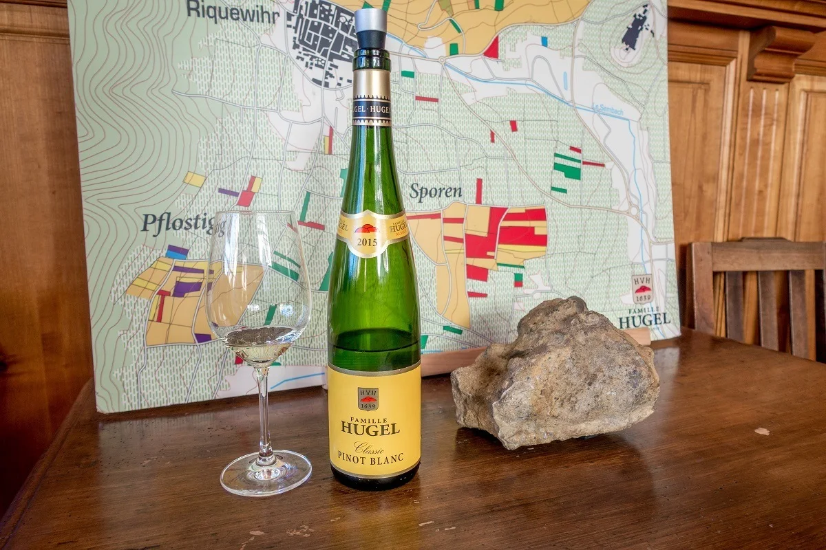 Wine glass and bottle at Alsace winery Hugel 