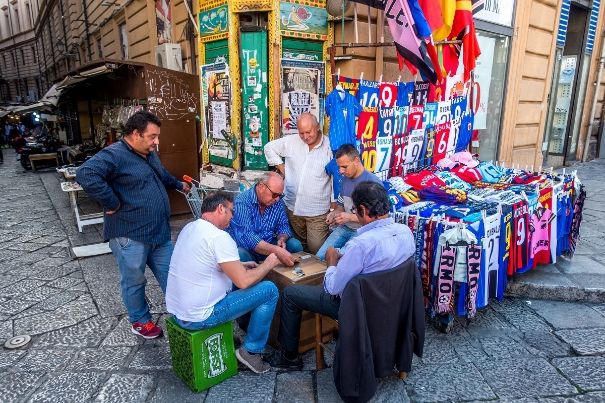 Men playing cards in an outdoor market