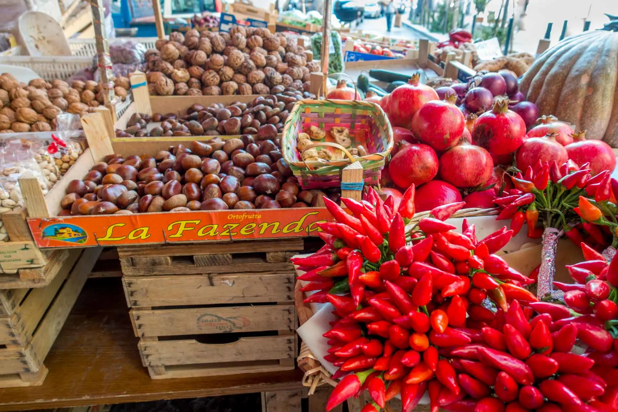 Fruit, vegetables, and nuts on display at a market.