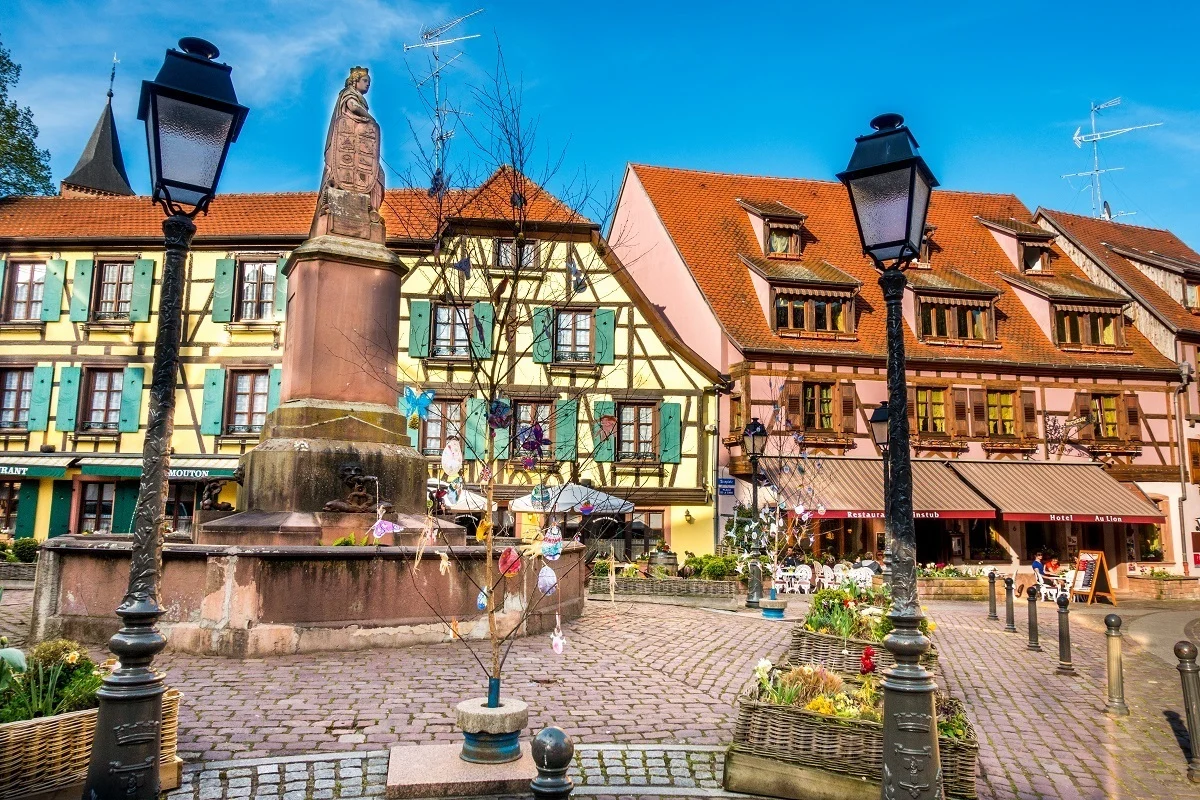 Fountain and buildings in Ribeauville, a fun stop on the Route des Vins d'Alsace