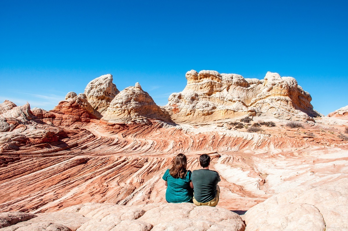 People sitting on rock formation 