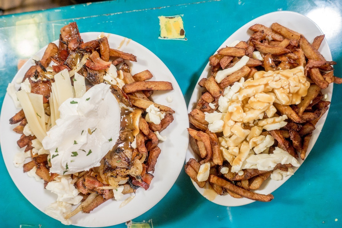 Plates of poutine--French fries with gravy and cheese