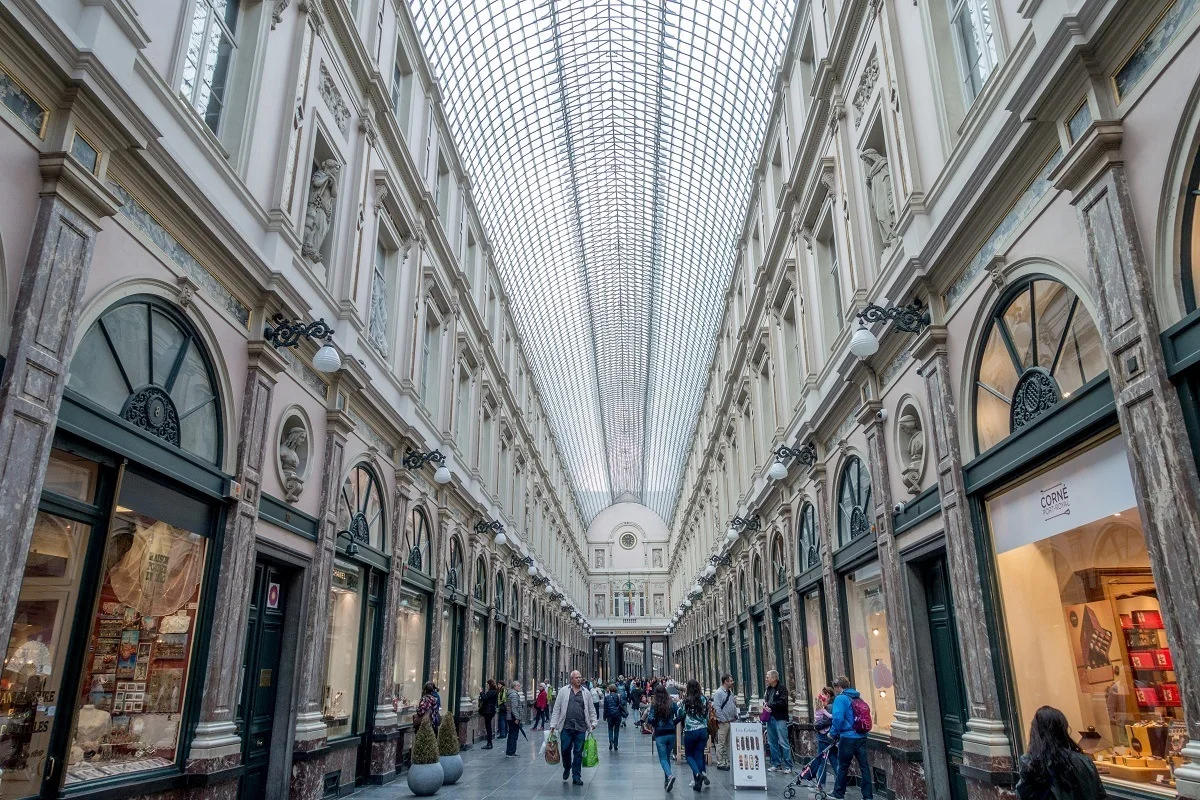 People walking through gallery of indoor shops