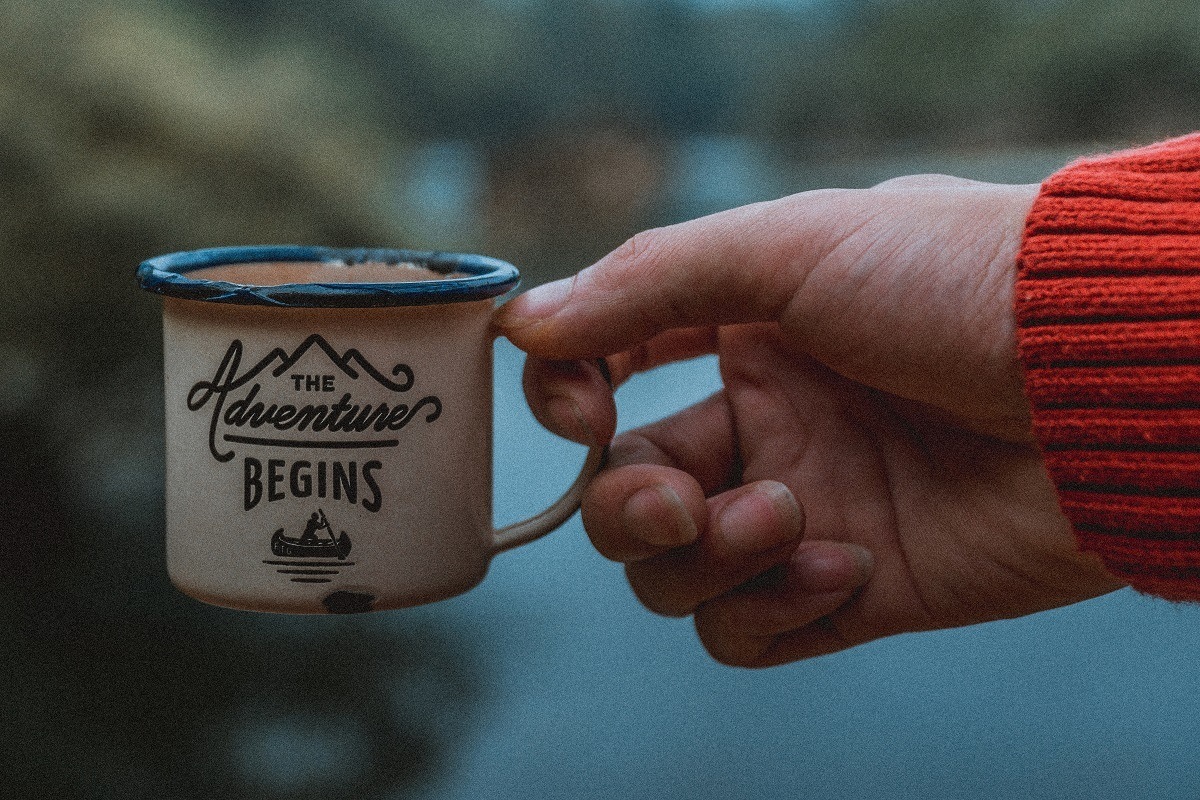 Coffee mug that says, "The Adventure Begins"