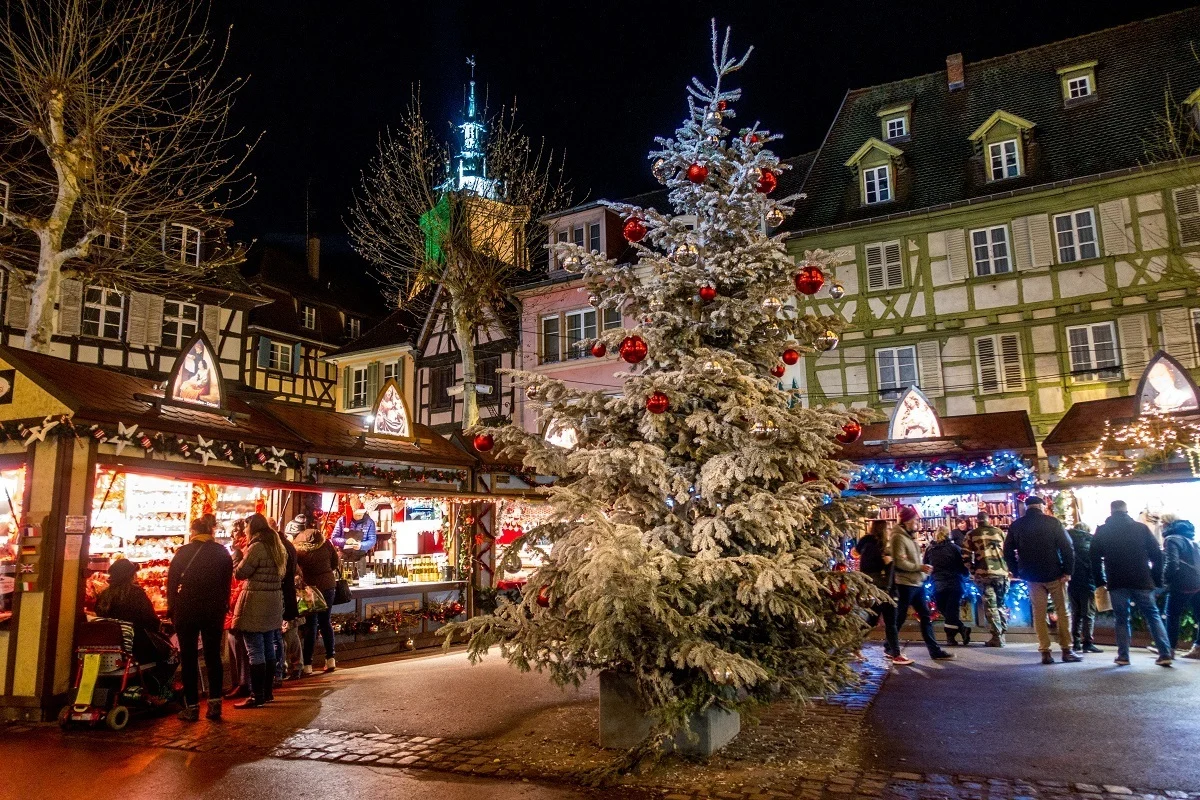 People shopping at Christmas market stalls at night