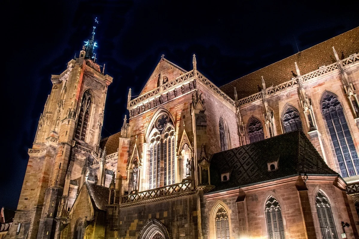 The red stone Collegiate Church of St. Martin lit up at night
