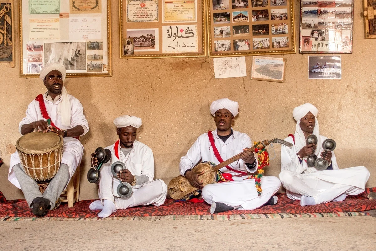 Seated Gnawa musicians performing. 