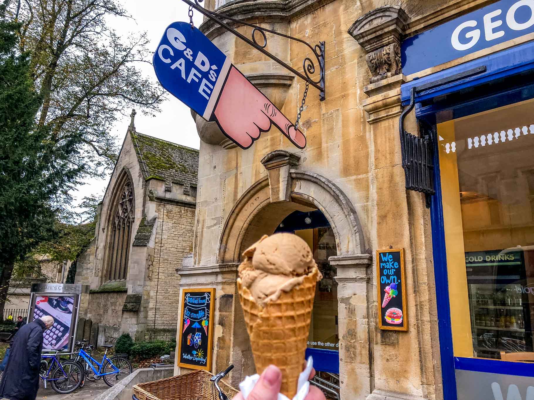 Ice cream cone in front of a hand-shaped sign for G&Ds cafe