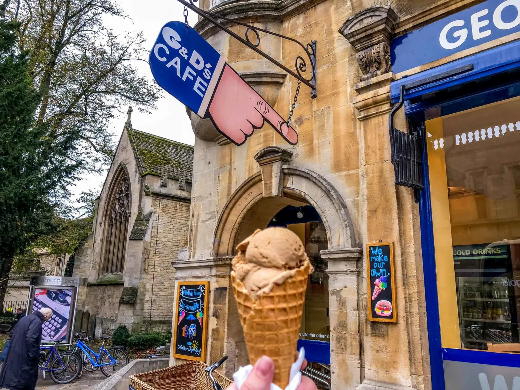 Ice cream cone in front of a hand-shaped sign for G&D's Cafe.