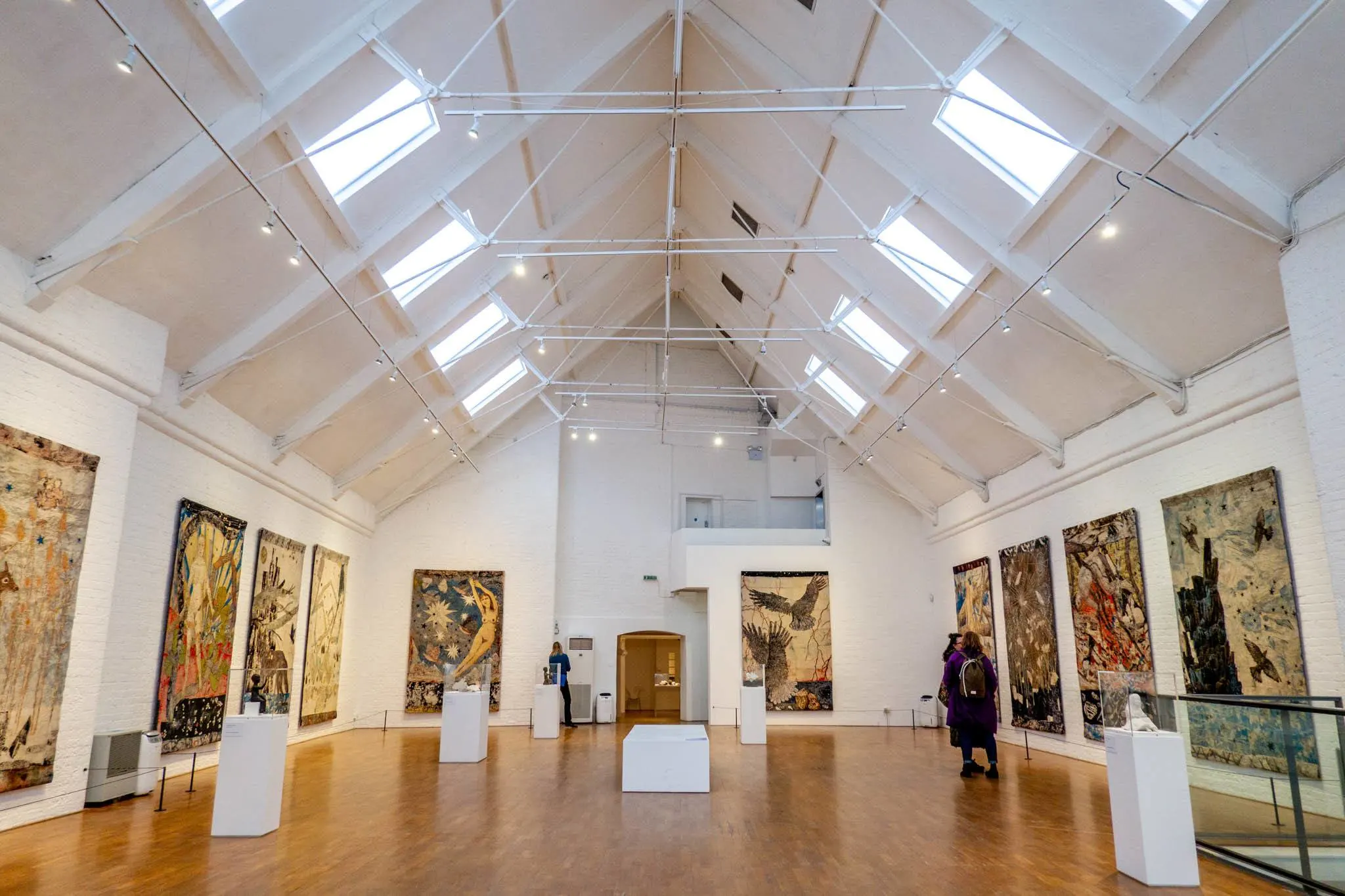 Large art gallery room with paintings on the walls. 