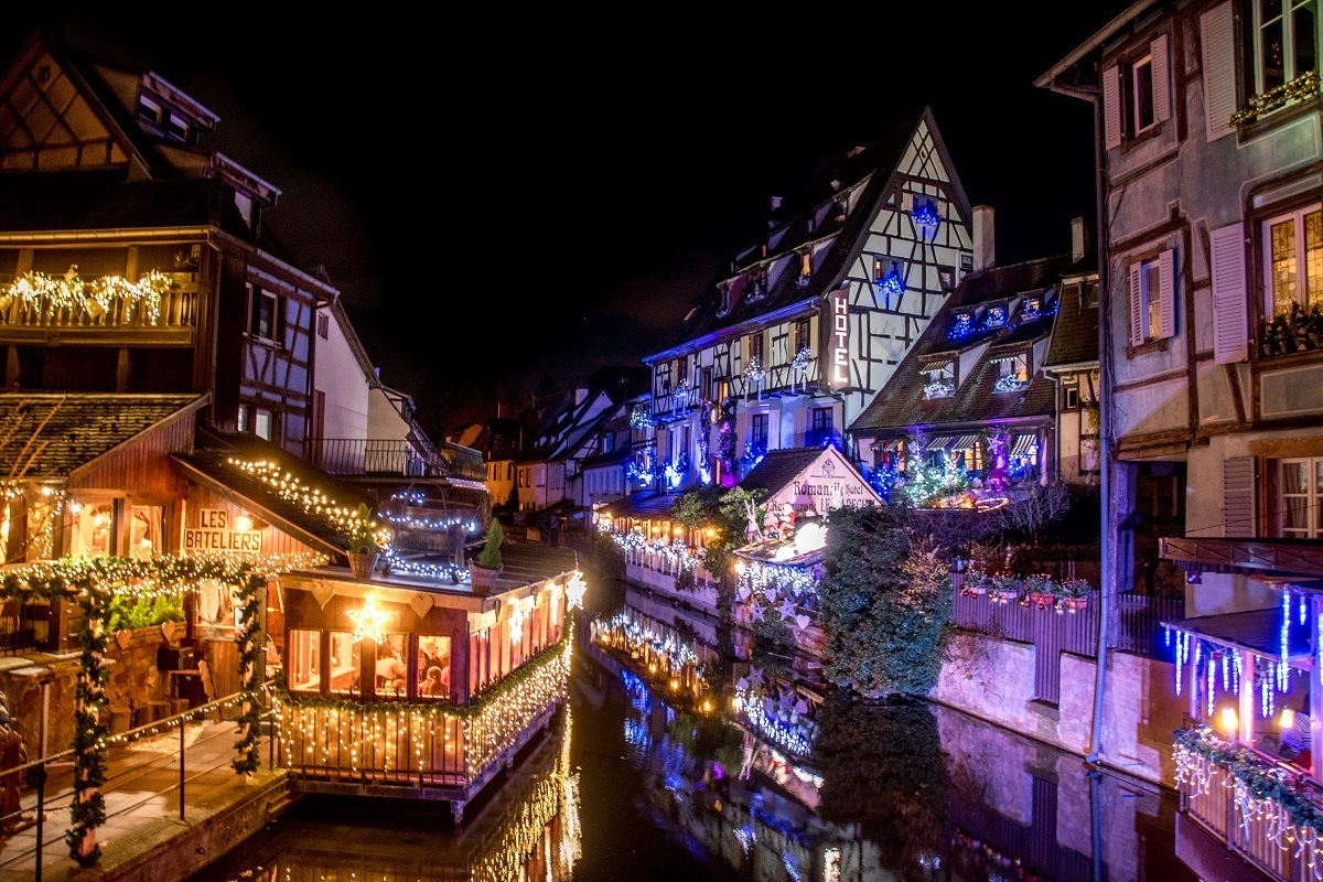 Colorful buildings in Petite Venise covered in Christmas lights