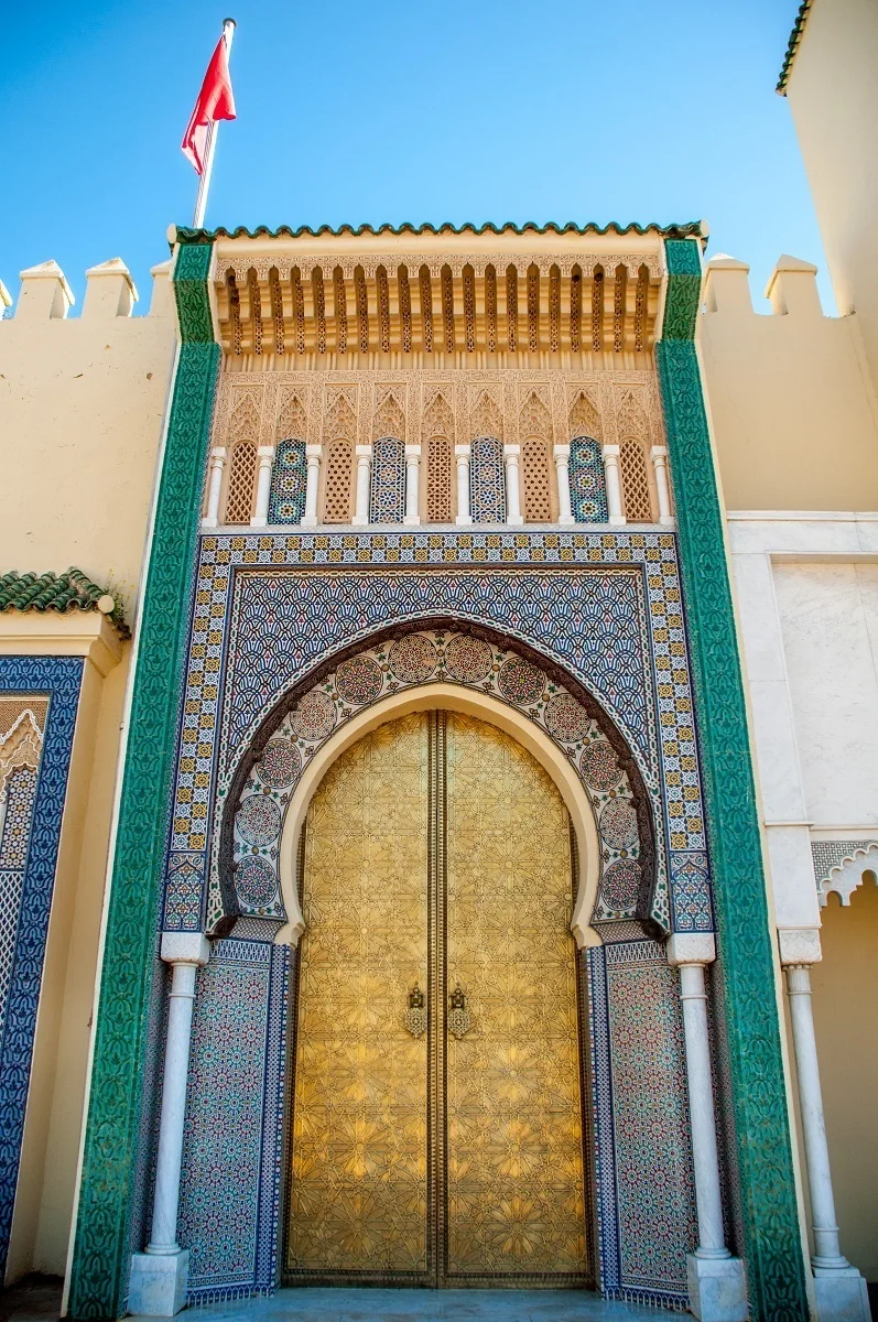 Golden and tiled palace gates.