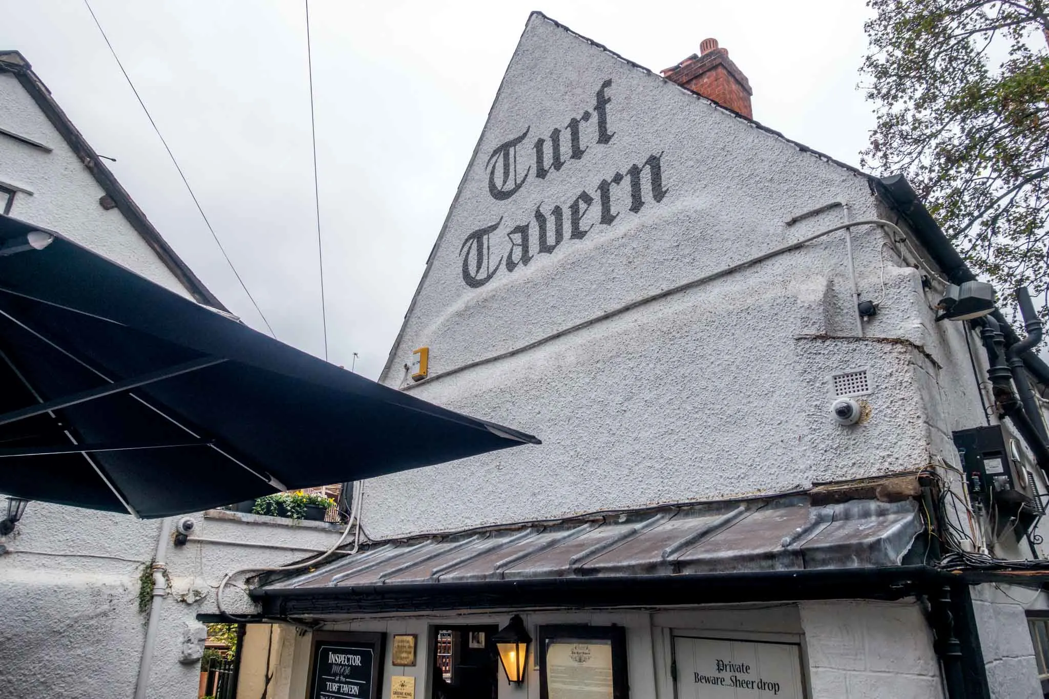 White exterior and sign at the historic Turf Tavern.