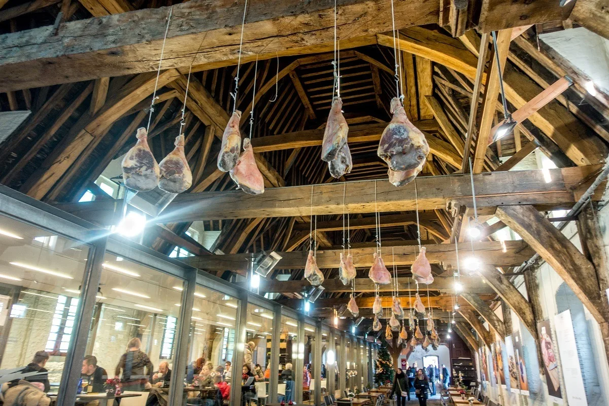 Interior of Butchers' Hall with hams hanging from ceiling.