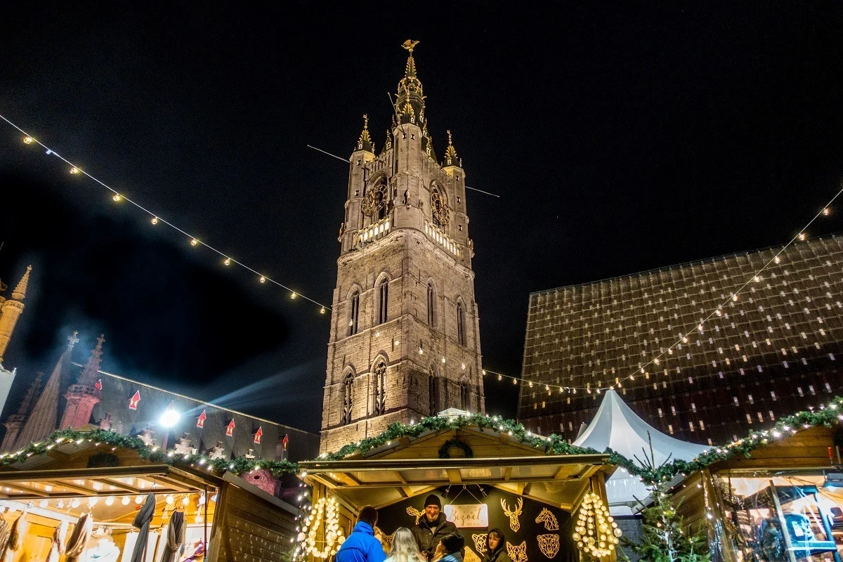 Christmas market stalls outside a church at night