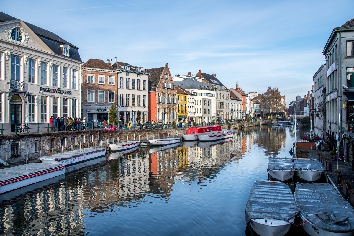 Buildings along Lys River with boats in Ghent Belgium
