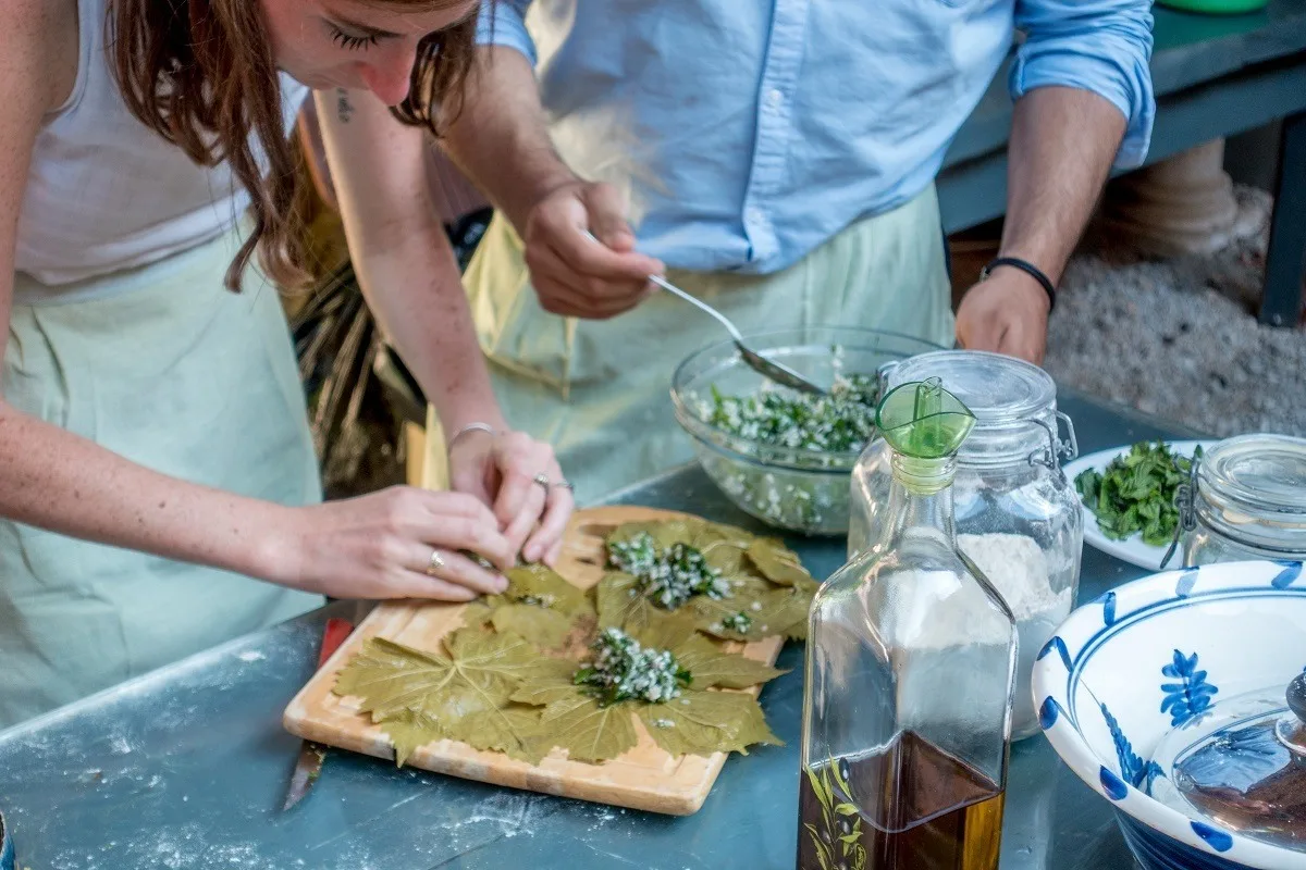 People making stuffed grape leaves at a cooking class