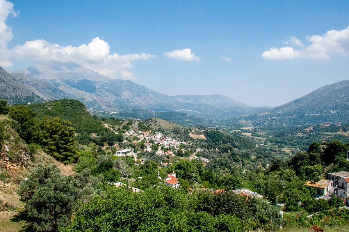 The lush, green mountains dotted with buildings