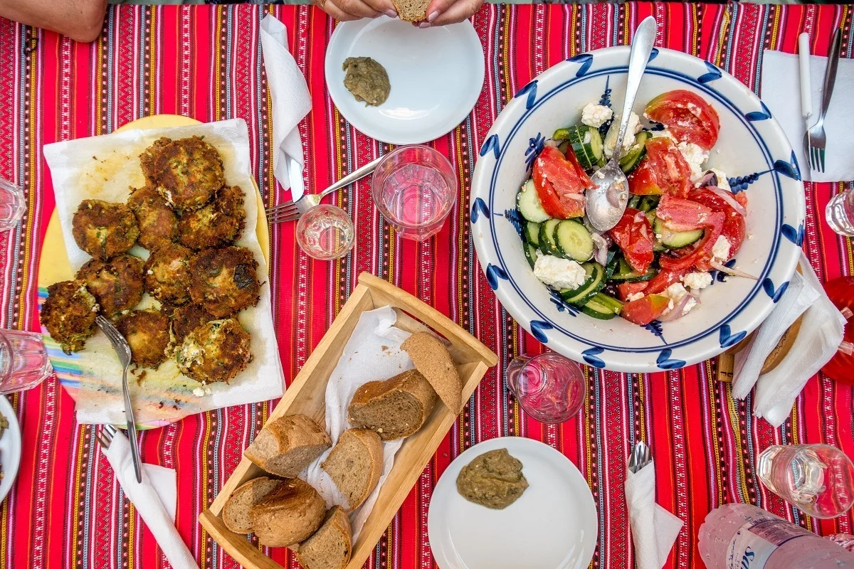 Fresh vegetables and zucchini fritters on a tablecloth 