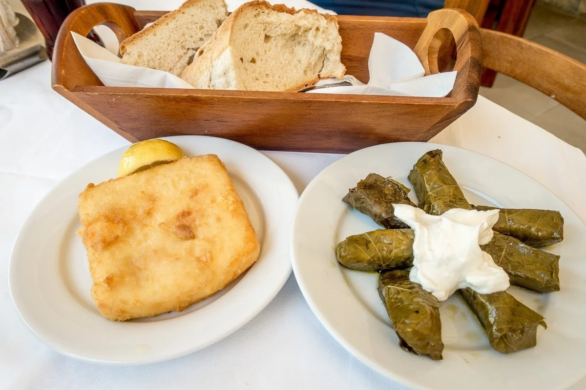 Stuffed grape leaves, fried saganaki cheese, and bread on table