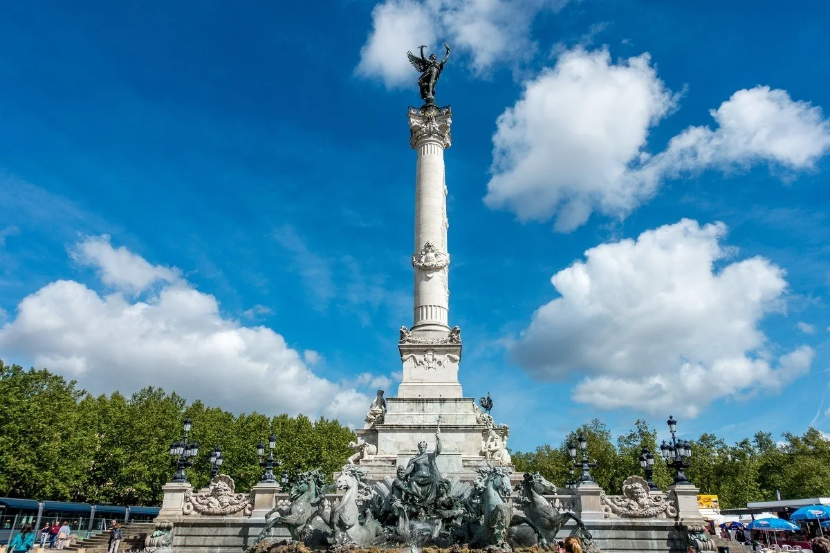 The Girondins Monument composed of a fountain and tower topped by a statue.