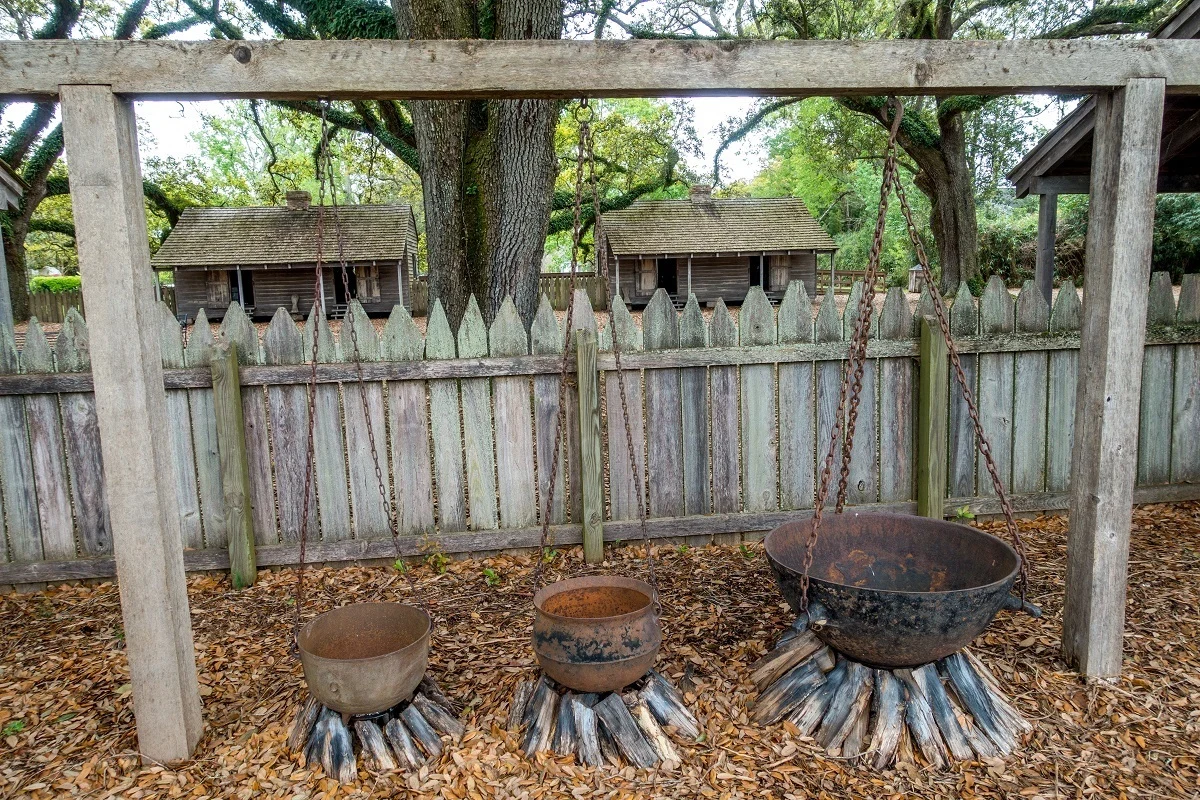 Kettles hanging over firewood