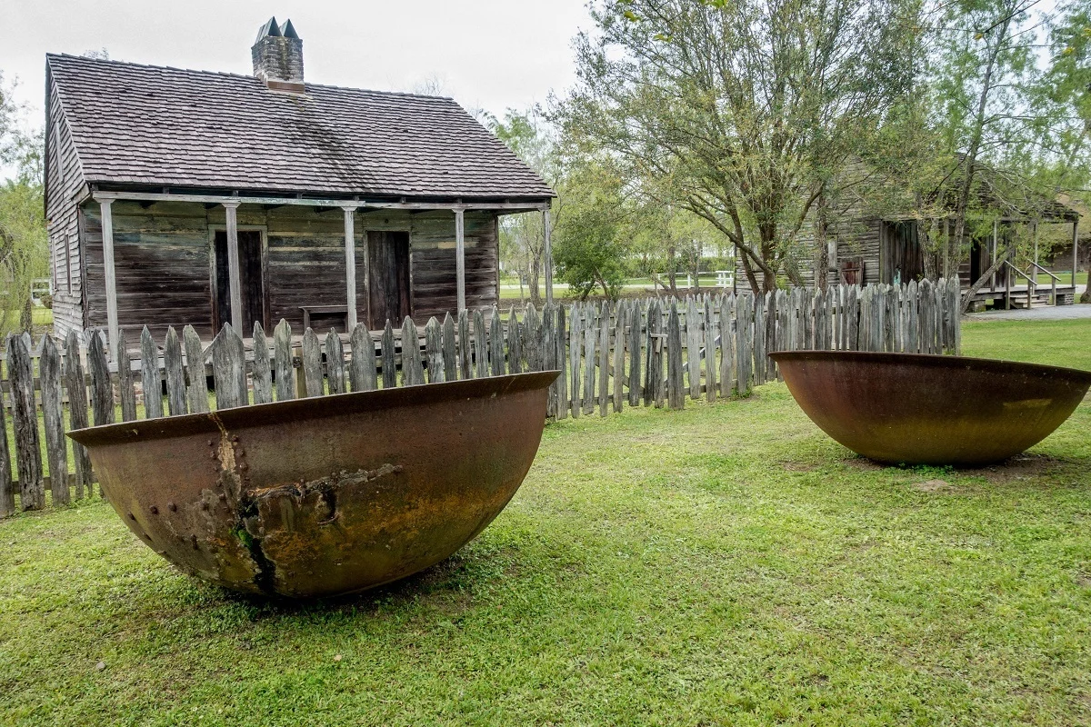 Sugar kettles and former slaves quarters at a New Orleans plantation