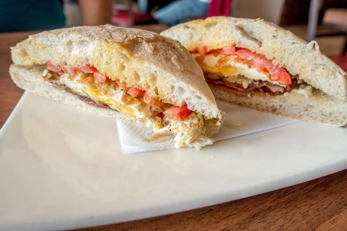 Traditional ftira bread used in a breakfast sandwich.