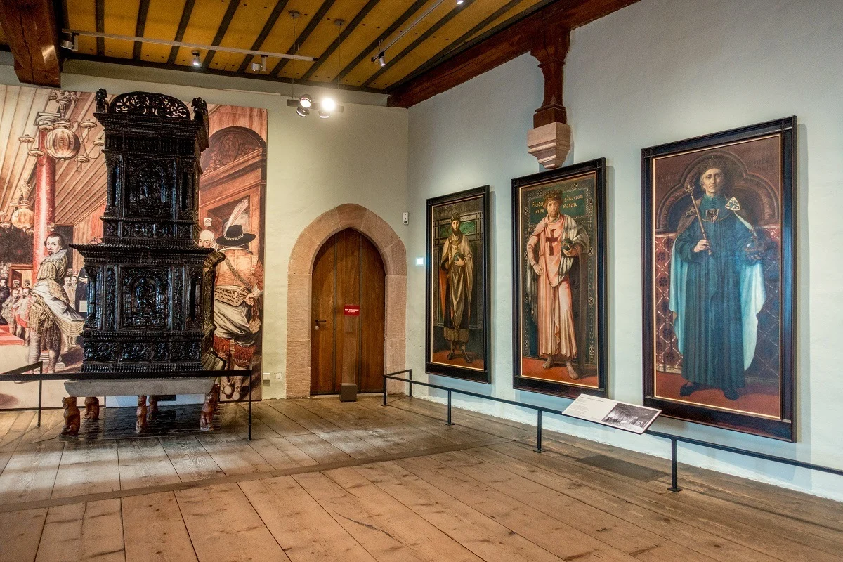 Paintings of emperors line a museum wall