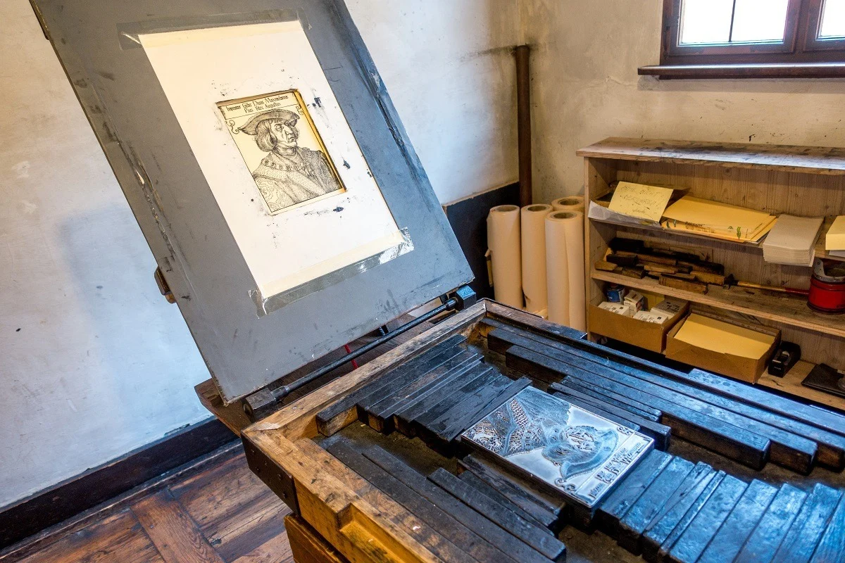 Copper plate engraving press with image of man