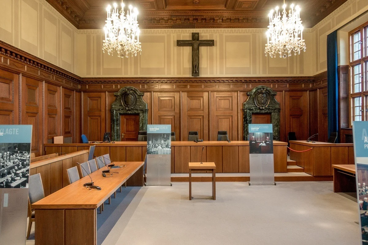 Courtroom with a judge's bench, place for the defendants, and posters 