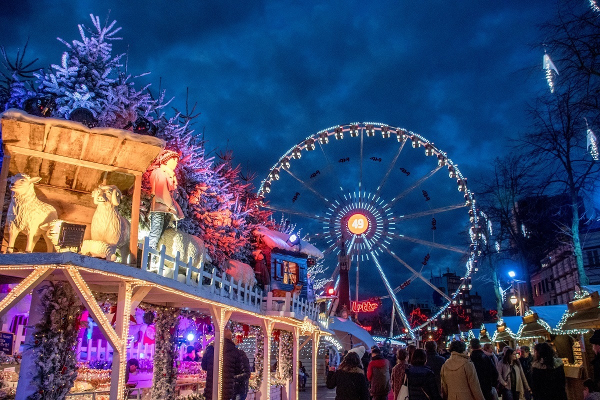 Ferris wheel and food stalls lit up.