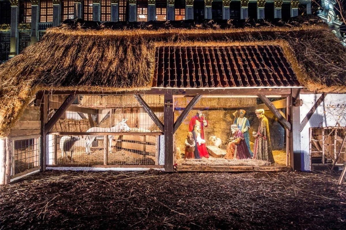 Nativity scene with people and animals in a barn