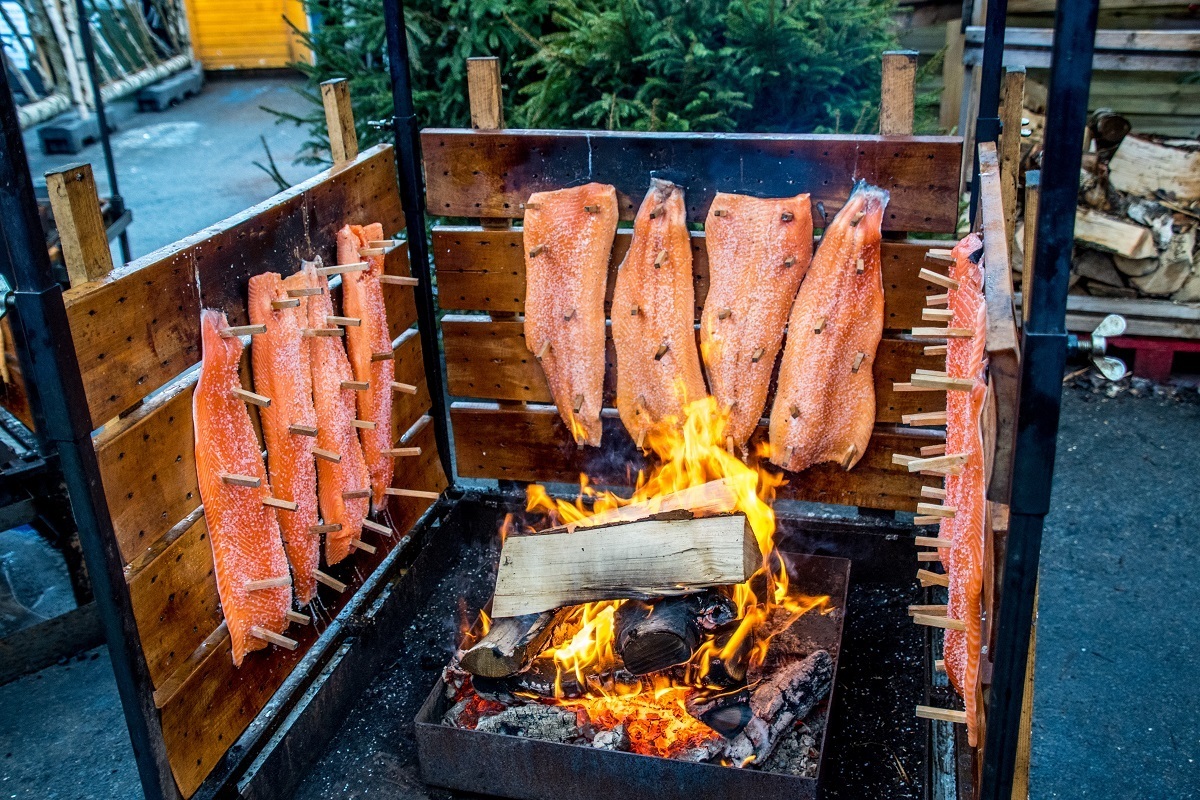 Salmon being smoked over an open fire