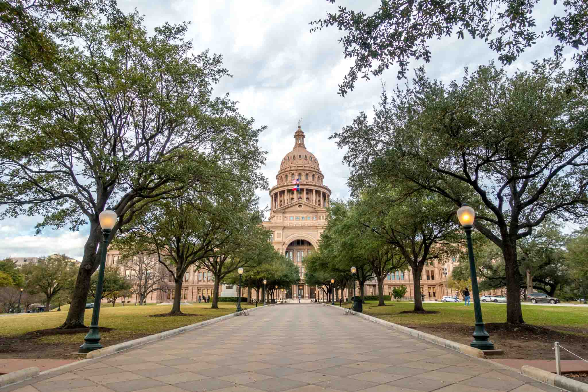 Tree-lined sidewalk leading to the Texas State Capitol 