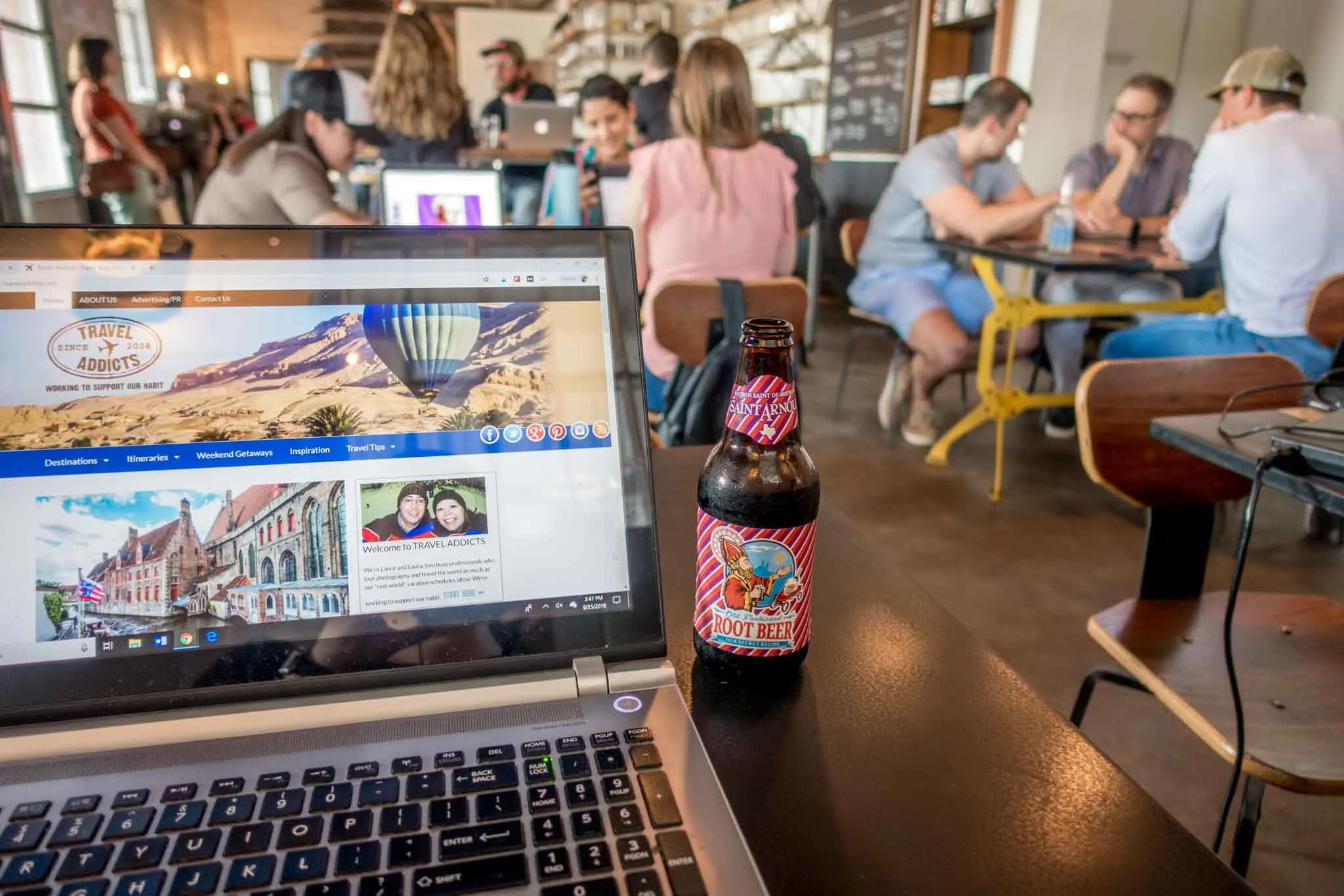 Computer and root beer on a table 