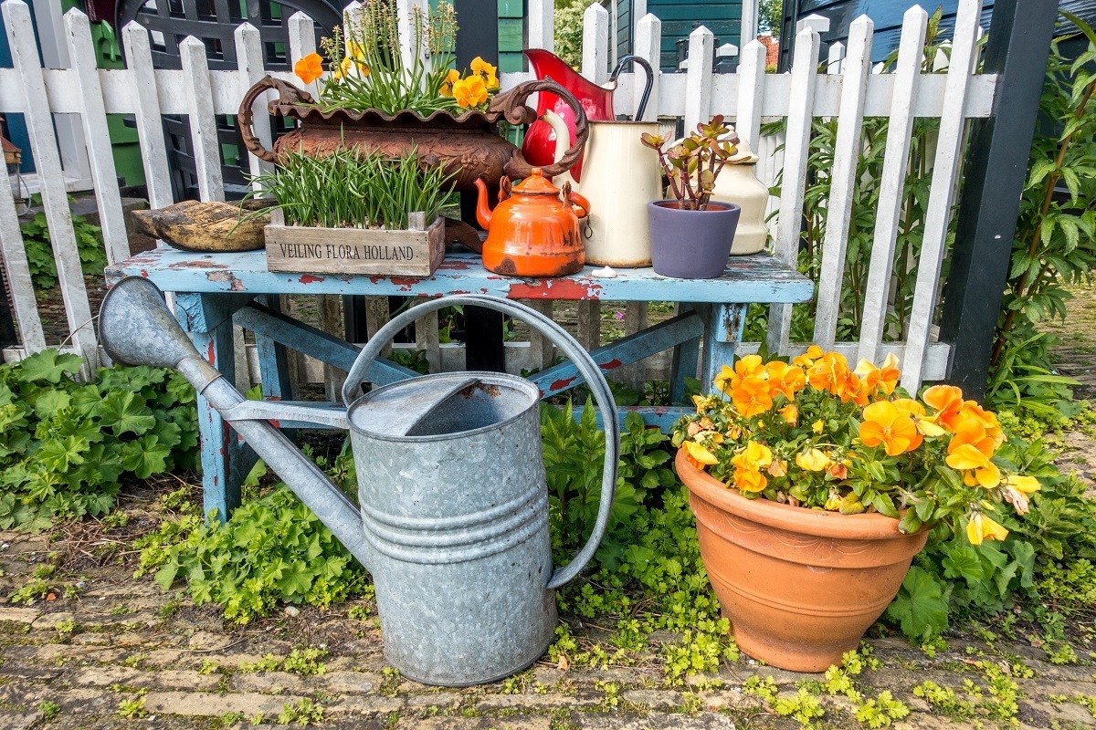 Flowers and decoration on a bench with watering can